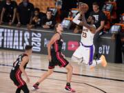 Los Angeles Lakers' LeBron James (23) takes a shot over Miami Heat's Kelly Olynyk (9) during the second half in Game 6 of basketball's NBA Finals Sunday, Oct. 11, 2020, in Lake Buena Vista, Fla. (AP Photo/Mark J.