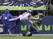 Seattle Seahawks' DK Metcalf, right, catches the ball in the end zone for a touchdown as Minnesota Vikings' Anthony Harris defends near the end of the second half of an NFL football game, Sunday, Oct. 11, 2020, in Seattle.