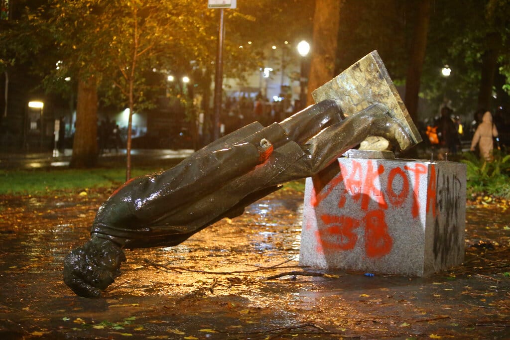 A group of protesters toppled statues of former presidents Theodore Roosevelt and Abraham Lincoln in Portland's South Park Block late Sunday, Oct. 11, 2020.