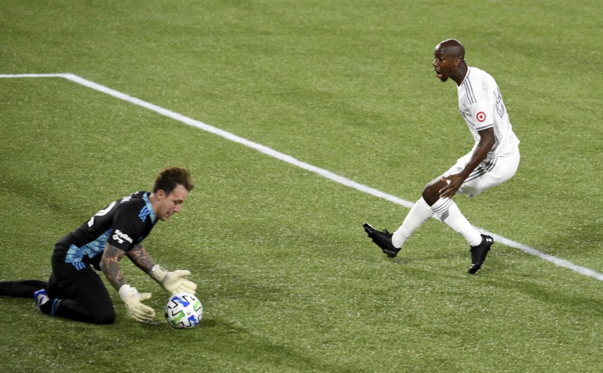 Portland Timbers goalkeeper Steve Clark, left, stops the shot of Los Angeles FC forward Bradley Wright-Phillips, right, during the first half of an MLS soccer match in Portland, Ore., Sunday, Oct. 18, 2020.