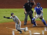 Tampa Bay Rays' Brandon Lowe watches his home run against the Los Angeles Dodgers during the first inning in Game 2 of the baseball World Series Wednesday, Oct. 21, 2020, in Arlington, Texas.