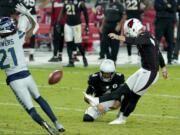 Arizona Cardinals kicker Zane Gonzalez kicks the game winning field goal as punter Andy Lee (4) holds during the second half of an NFL football game against the Seattle Seahawks, Sunday, Oct. 25, 2020, in Glendale, Ariz. The Cardinals won 37-34 in overtime.