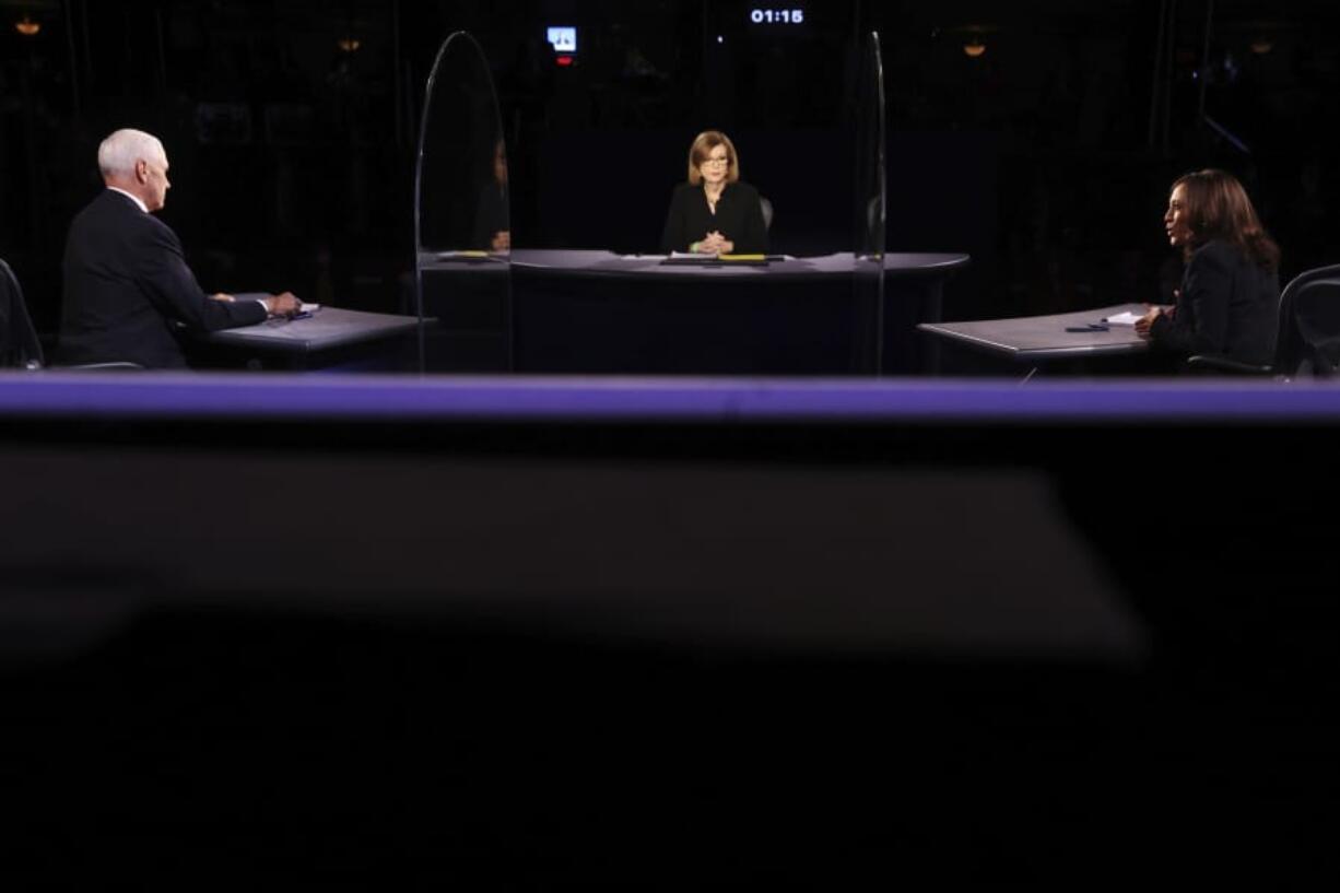 Vice President Mike Pence listens as Democratic vice presidential candidate Sen. Kamala Harris, D-Calif., speaks during the vice presidential debate Wednesday, Oct. 7, 2020, at Kingsbury Hall on the campus of the University of Utah in Salt Lake City.