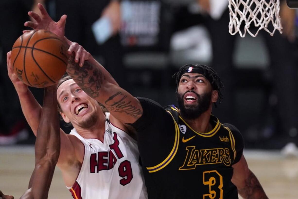 Miami Heat forward Kelly Olynyk (9) and Los Angeles Lakers forward Anthony Davis (3) compete for control of a rebound during the second half of Game 2 of basketball&#039;s NBA Finals, Friday, Oct. 2, 2020, in Lake Buena Vista, Fla. (AP Photo/Mark J.