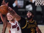 Miami Heat forward Kelly Olynyk (9) and Los Angeles Lakers forward Anthony Davis (3) compete for control of a rebound during the second half of Game 2 of basketball&#039;s NBA Finals, Friday, Oct. 2, 2020, in Lake Buena Vista, Fla. (AP Photo/Mark J.