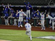 The Los Angeles Dodgers celebrate a three-run home run by Will Smith against the Atlanta Braves during the sixth inning in Game 5 of a baseball National League Championship Series Friday, Oct.