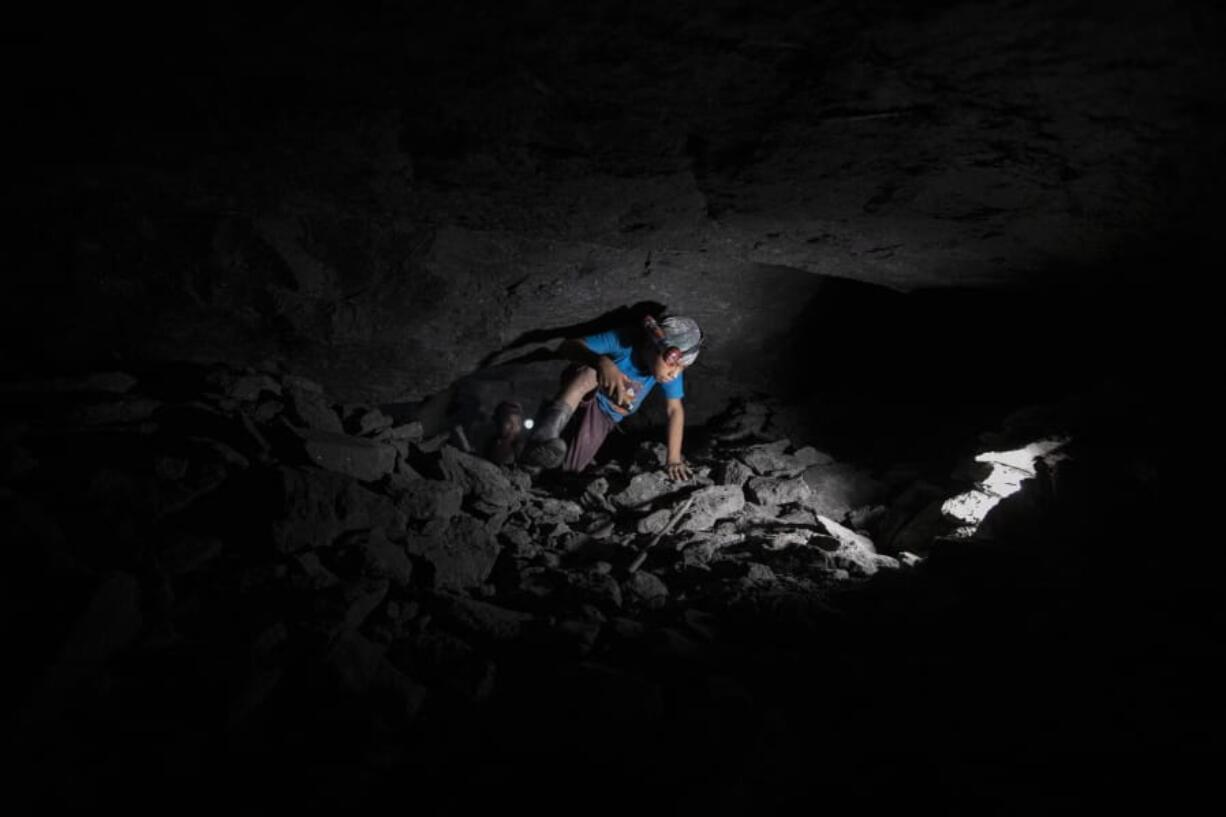 Andres Gomez works inside an amber mine near the community of Jotolchen II in Chiapas state, Mexico, Thursday, Sept. 10, 2020. The 11-year-old said that before the new coronavirus pandemic hit, he attended school and then would spend a couple of hours mining after class, but since the school closed in March he is spending entire days mining.