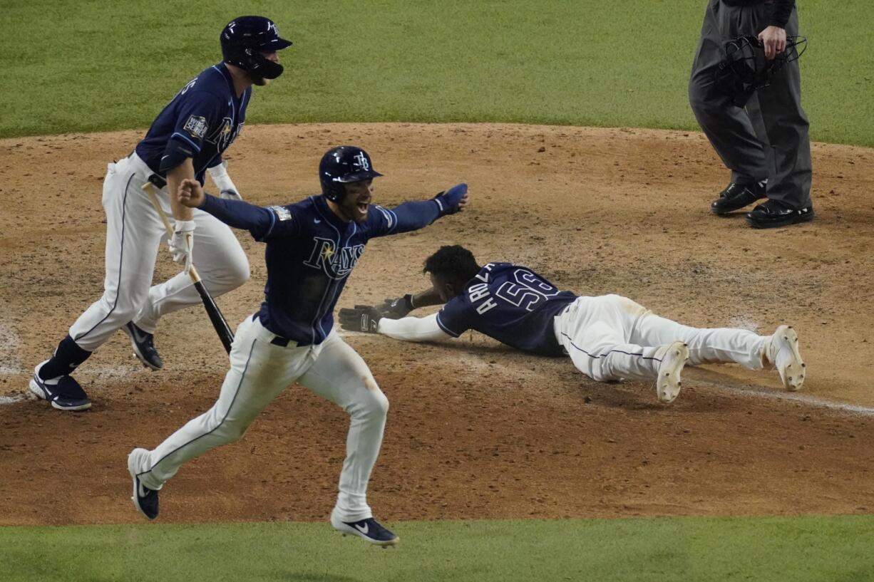 Tampa Bay Rays' Randy Arozarena celebrates after scoring the winning run in Game 4 of the baseball World Series against the Los Angeles Dodgers Saturday, Oct. 24, 2020, in Arlington, Texas. Rays defeated the Dodgers 8-7 to tie the series 2-2 games.