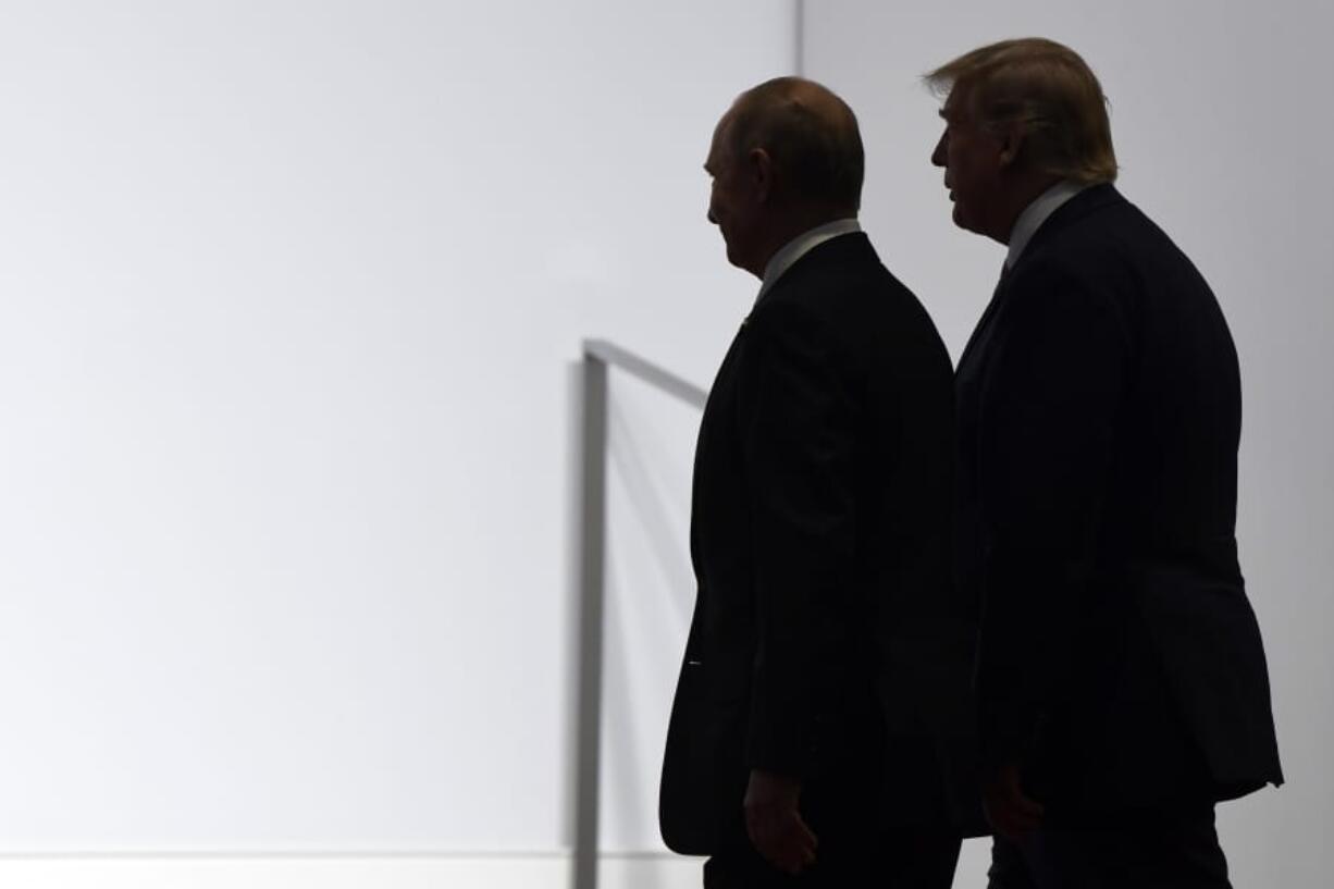 FILE - In this June 28, 2019, file photo President Donald Trump and Russian President Vladimir Putin walk to participate in a group photo at the G20 summit in Osaka, Japan.  Most Americans are concerned at least somewhat by the potential for foreign interference in November&#039;s election, and a majority believes that Russian sought in 2016 to influence the outcome of that race.