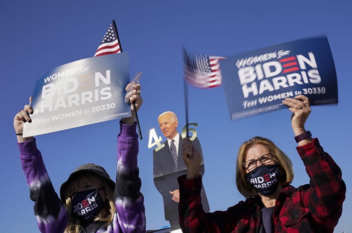 Supporters listen as Democratic presidential candidate former Vice President Joe Biden speaks at a rally at the Iowa State Fairgrounds in Des Moines, Iowa, Friday, Oct. 30, 2020.