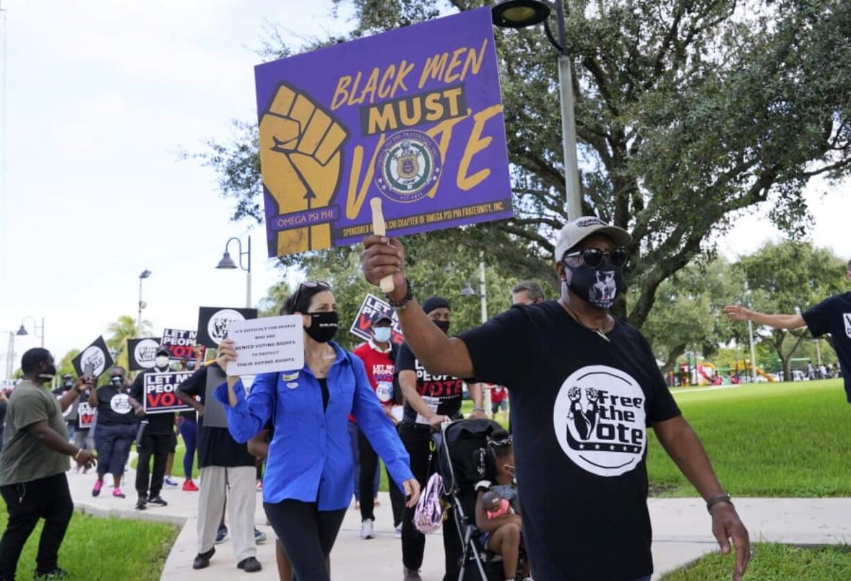 Supporters of restoring Florida felons&#039; voting rights march to an early voting precinct, Saturday, Oct. 24, 2020, in Fort Lauderdale, Fla. The Florida Rights Restoration Coalition led marches to the polls in dozens of Florida counties.