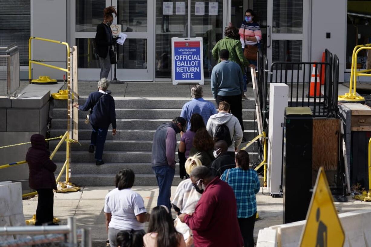 Residents line up outside the Montgomery County, Pa., Voter Services office, Monday, Oct. 19, 2020, in Norristown, Pa. Monday is the last day in Pennsylvania to register to vote in the Nov. 3 election in which the presidential battleground state is playing a central role in the contest between President Donald Trump and former Vice President Joe Biden.