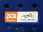 FILE - In this Aug. 5, 2020, file photo a vote-by-mail ballot is shown as viewed through the handle of a sorting tray at the King County Elections headquarters in Renton, Wash., south of Seattle. U.S. Postal Service records show delivery delays have persisted across the country as millions of Americans began voting by mail, raising the possibility of ballots being rejected because they arrive too late. Postal data covering the beginning of October show nearly all of the agency&#039;s delivery regions missing agency targets of having more than having more than 95% of first-class mail arrive within five days. (AP Photo/Ted S.