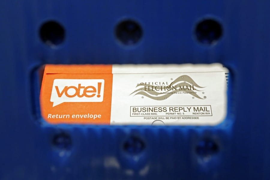 FILE - In this Aug. 5, 2020, file photo a vote-by-mail ballot is shown as viewed through the handle of a sorting tray at the King County Elections headquarters in Renton, Wash., south of Seattle. U.S. Postal Service records show delivery delays have persisted across the country as millions of Americans began voting by mail, raising the possibility of ballots being rejected because they arrive too late. Postal data covering the beginning of October show nearly all of the agency&#039;s delivery regions missing agency targets of having more than having more than 95% of first-class mail arrive within five days. (AP Photo/Ted S.