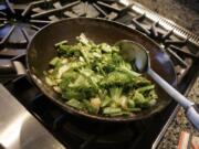 FILE - This Aug. 5, 2006 file photo shows a vegetable stir fry dish being prepared in New York. Stir-fry technique has many people intimidated. But if you can slice and stir, you can stir fry.