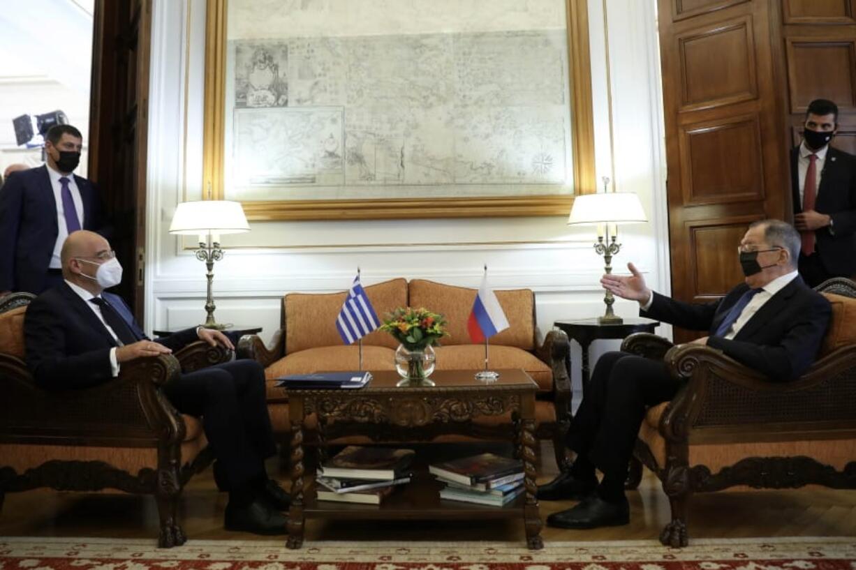 Greek Foreign Minister Nikos Dendias, left, listens his Russian counterpart Sergei Lavrov during their meeting in Athens, Monday, Oct. 26, 2020. The talks of the two diplomats are focus on the situation between Greece and Turkey as the neighbour country announced late Saturday that it is extending by one week a gas exploration mission in the eastern Mediterranean that has caused tensions with Greece.