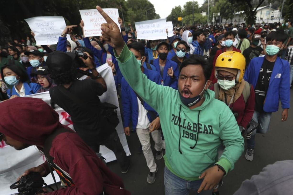 Protesters shout slogans during a rally against the new jobs law in Jakarta, Indonesia,Tuesday, Oct. 20, 2020. Protests against Indonesia&#039;s new jobs law were held in cities across the country on Tuesday, with demonstrators calling on the president to revoke the legislation they say will erode labor rights and weaken environmental protections.