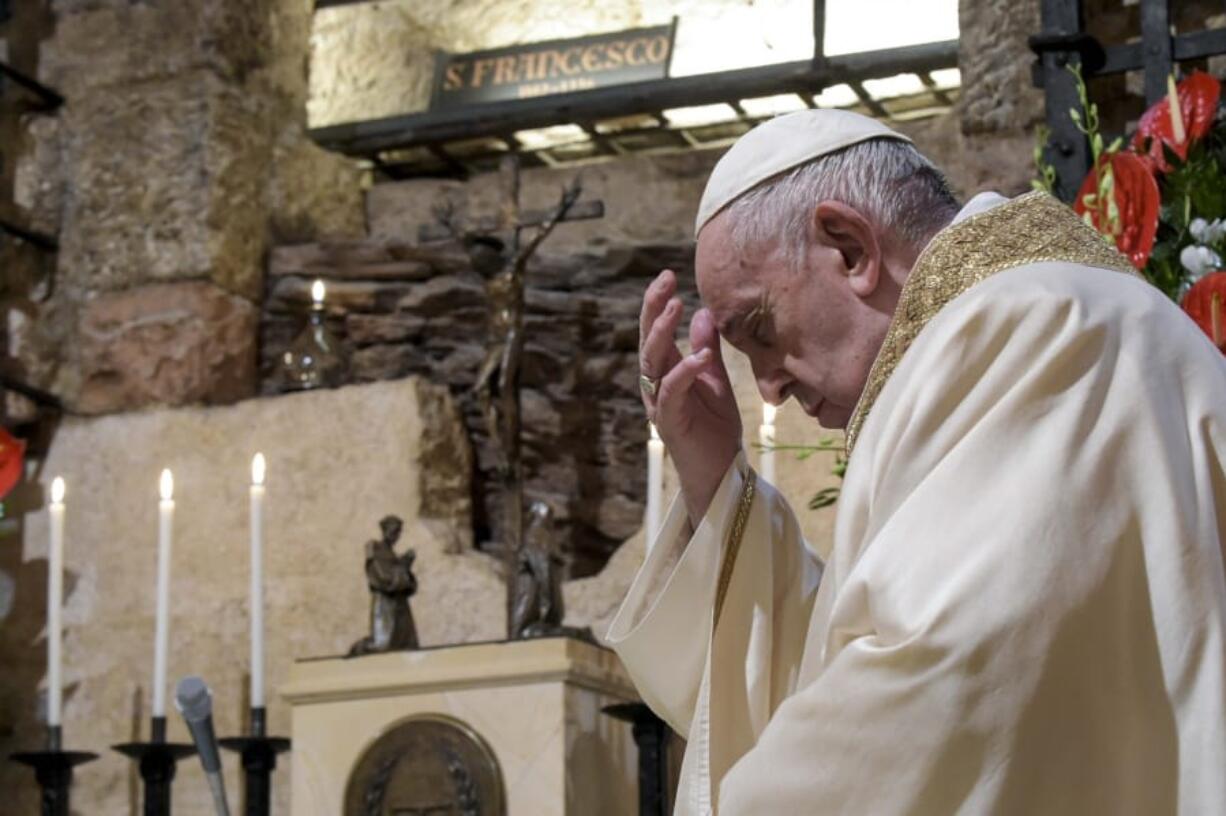 Pope Francis celebrates Mass on Saturday in the crypt of the Basilica of St. Francis in Assisi, Italy.