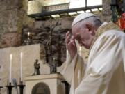 Pope Francis celebrates Mass on Saturday in the crypt of the Basilica of St. Francis in Assisi, Italy.