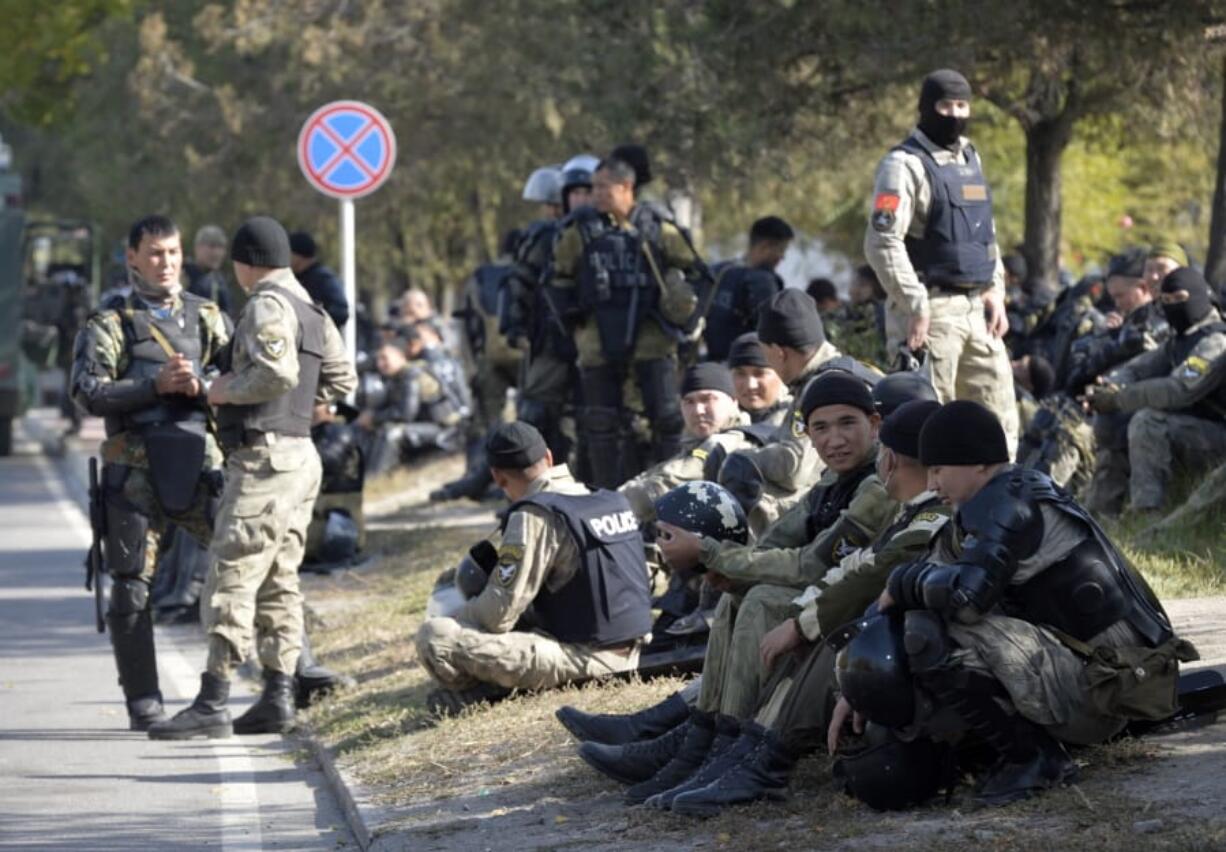 Kyrgyz police soldiers on a street in Bishkek, Kyrgyzstan, Thursday, Oct. 15, 2020. Kyrgyzstan President Sooronbai Jeenbekov announced his resignation on Thursday in a bid to end the turmoil that has engulfed the Central Asian nation after a disputed parliamentary election.