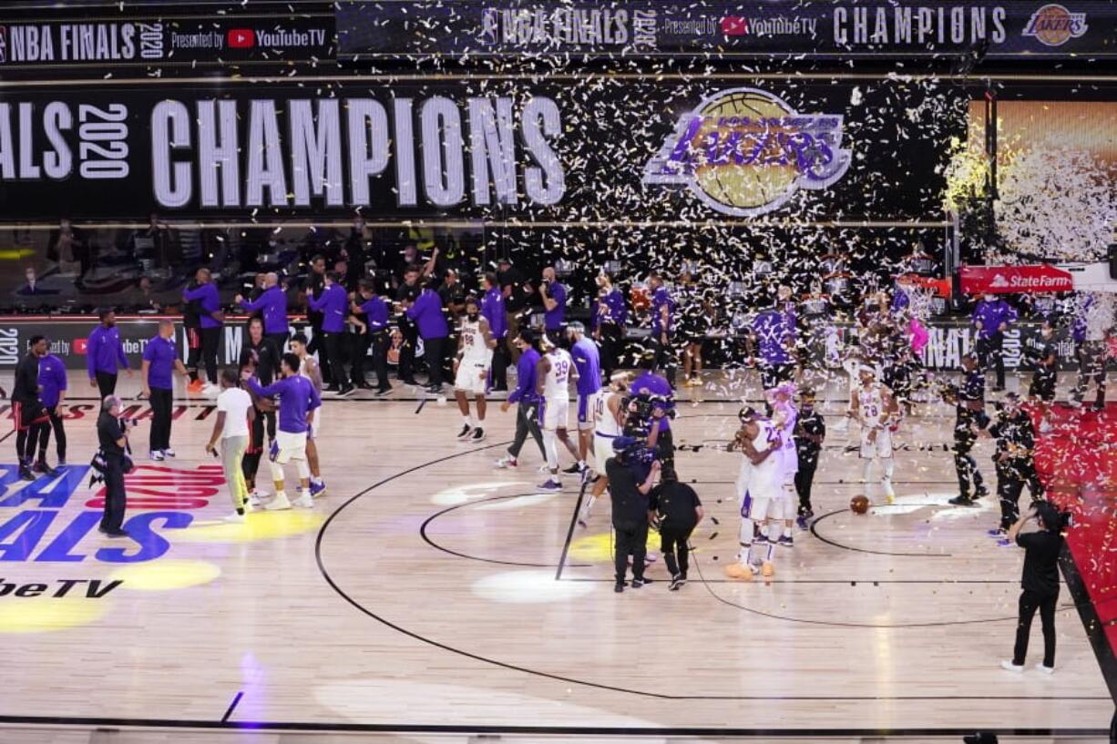 The Los Angeles Lakers players celebrate after the Lakers defeated the Miami Heat 106-93 in Game 6 of basketball&#039;s NBA Finals Sunday, Oct. 11, 2020, in Lake Buena Vista, Fla. (AP Photo/Mark J.