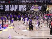 The Los Angeles Lakers players celebrate after the Lakers defeated the Miami Heat 106-93 in Game 6 of basketball&#039;s NBA Finals Sunday, Oct. 11, 2020, in Lake Buena Vista, Fla. (AP Photo/Mark J.