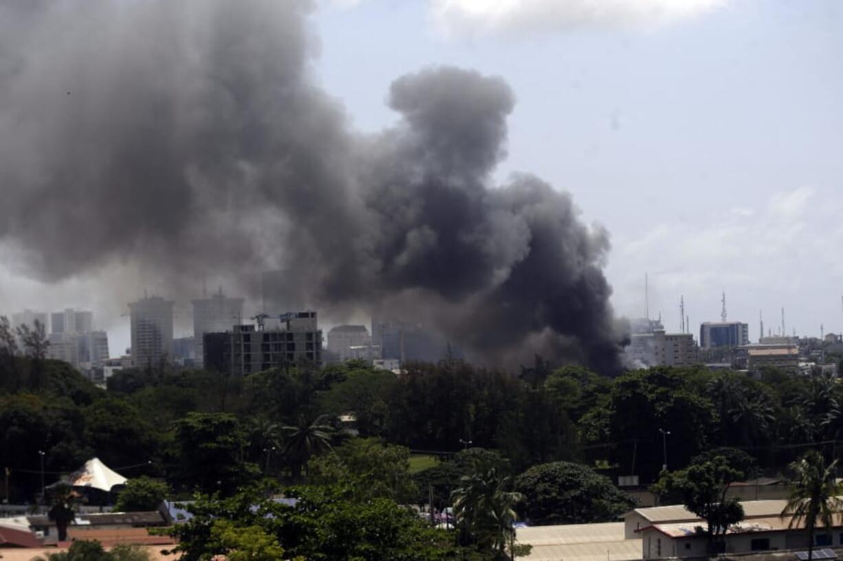 Smoke rises from the Nigeria Correctional service facility in Lagos, Nigeria, Thursday Oct. 22, 2020. Plumes of smoke rose above a prison in Lagos and gunfire could be heard as people ran through streets in the area on Thursday, a sign of continued unrest in Nigeria, which has been gripped by two weeks of protests against police brutality.