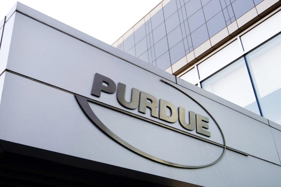 FILE - This Tuesday, May 8, 2007, file photo shows the Purdue Pharma logo at its offices in Stamford, Conn. Purdue Pharma, the company that makes OxyContin, the powerful prescription painkiller that experts say helped touch off an opioid epidemic, will plead guilty to three federal criminal charges as part of a settlement of over $8 billion, Justice Department officials told The Associated Press.