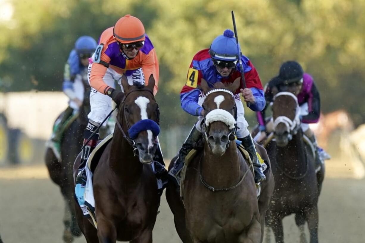 Swiss Skydiver (4), ridden by Robby Albarado, wins the 145th Preakness Stakes horse race ahead of  Authentic (9), ridden by John Velazquez, at Pimlico Race Course, Saturday, Oct. 3, 2020, in Baltimore.