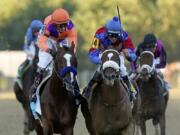 Swiss Skydiver (4), ridden by Robby Albarado, wins the 145th Preakness Stakes horse race ahead of  Authentic (9), ridden by John Velazquez, at Pimlico Race Course, Saturday, Oct. 3, 2020, in Baltimore.