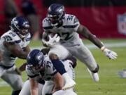 Seattle Seahawks running back Chris Carson (32) runs against the Arizona Cardinals during the first half of an NFL football game, Sunday, Oct. 25, 2020, in Glendale, Ariz. (AP Photo/Ross D.