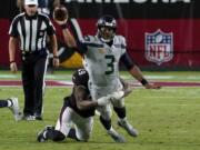 Seattle Seahawks quarterback Russell Wilson (3) gets the throw off as Arizona Cardinals linebacker Kylie Fitts makes the hit during the second half of an NFL football game, Sunday, Oct. 25, 2020, in Glendale, Ariz. (AP Photo/Rick Scuteri) (Associated Press/Ross D.