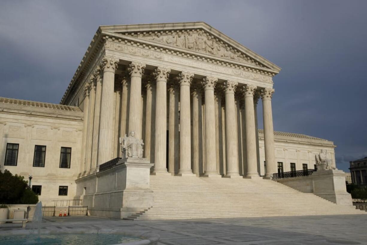 The setting sun shines on the Supreme Court building in Washington. The court opens a new term Monday.