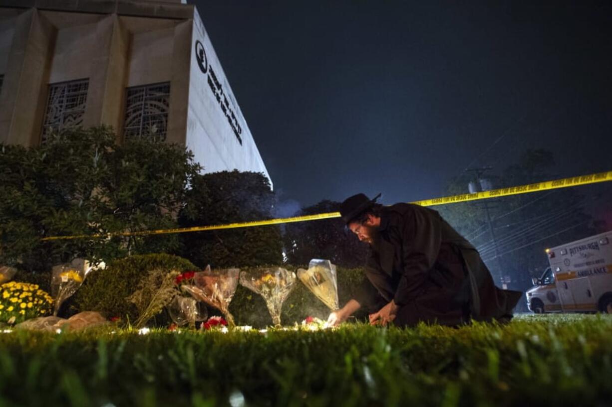 Rabbi Eli Wilansky lights a candle after a mass shooting at Tree of Life Synagogue in Pittsburgh&#039;s Squirrel Hill neighborhood on Oct. 27, 2018.