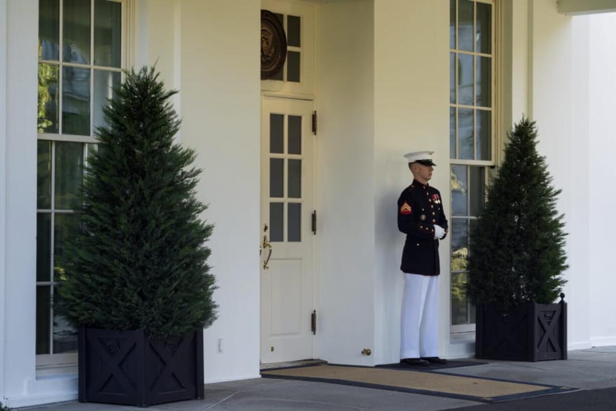 A Marine is posted outside the West Wing of the White House, signifying the President is in the Oval Office, Wednesday, Oct. 7, 2020, in Washington.