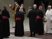 Pope Francis, right, greets bishops Wednesday at the end of his weekly general audience in the Paul VI hall at the Vatican.