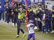 Seattle Seahawks&#039; DK Metcalf (14) pulls in a long pass reception on the Seahawks&#039; last series of an NFL football game as Minnesota Vikings&#039; Cameron Dantzler defends late in the second half, Sunday, Oct. 11, 2020, in Seattle. The Seahawks won 27-26. (AP Photo/Ted S.