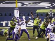 Seattle Seahawks quarterback Russell Wilson passes against the Minnesota Vikings late in the second half of an NFL football game, Sunday, Oct. 11, 2020, in Seattle. (AP Photo/Ted S.