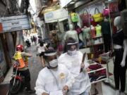 Health workers walk through the Rocinha slum to test people for COVID-19 as part of a rapid test campaign by the civilian organization &quot;Bora Testar,&quot; or &quot;Let&#039;s Test&quot; in Rio de Janeiro, Brazil, Thursday, Oct. 8, 2020. Financed by crowdfunding and donations, the organization says it aims to test up to 300 people in the slum.