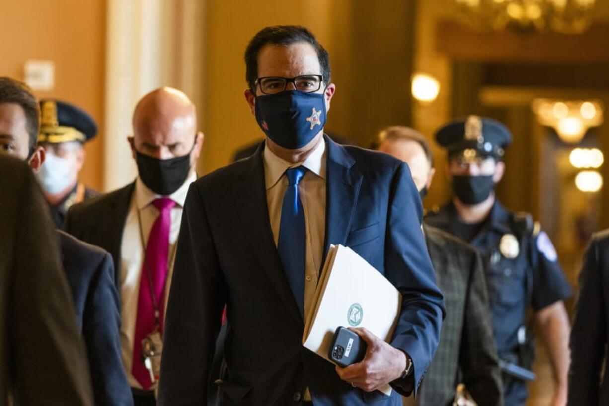 Treasury Secretary Steven Mnuchin, walks from the office of Senate Majority Leader Sen. Mitch McConnell of Ky., as he leaves the Capitol, Wednesday, Sept. 30, 2020, in Washington. Mnuchin earlier met with House Speaker Nancy Pelosi of Calif.