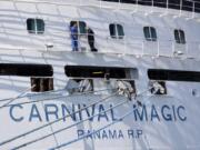 FILE - In this April 4, 2020 file photo, workers perform maintenance on the Carnival cruise line ship Carnival Magic while it is docked at Port Canaveral,  in Cape Canaveral, Fla.  Carnival Cruise Line is canceling most U.S. sailings through the end of this year. It&#039;s the latest sign that the cruise industry&#039;Aos recovery from the coronavirus pandemic could still be many months away. The company says it&#039;s canceling sailings from all ports except its home ports of Miami and Port Canaveral, Florida, but it stressed that it still might not sail from those ports in November and December.