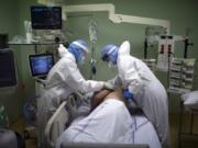 A medical crew treat a COVID-19 patient in the intensive care unit at the Joseph Imbert Hospital Center in Arles, southern France, Wednesday, Oct. 28, 2020. Many French doctors are urging a new nationwide lockdown, noting that 58% of the country&#039;s intensive care units are now occupied by COVID patients and medical staff are under increasing strain.