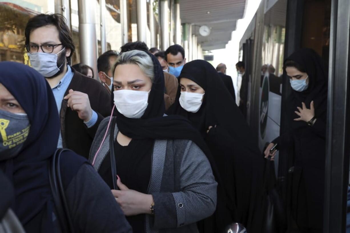 FILE - In this Sunday, Oct. 11, 2020 file photo, people wear protective face masks to help prevent the spread of the coronavirus in downtown Tehran, Iran. For the second day in a row, Iran announced Monday its highest single-day death toll from the coronavirus with 272 people killed.