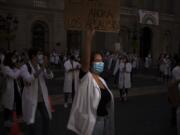 Medical residents take part in a protest against their working conditions during a strike in Barcelona, Spain, Tuesday, Oct. 20, 2020. Regional authorities across Spain continue to tighten restrictions against a sharp resurgence of coronavirus infections that is bringing the country&#039;s cumulative caseload close to one million infections, the highest tally in western Europe.