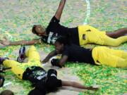 Seattle Storm players, including Mercedes Russell, top, play in the confetti after the team won the WNBA Finals Tuesday  in Bradenton, Fla. The Storm swept the Las Vegas Aces in the best-of-five series.