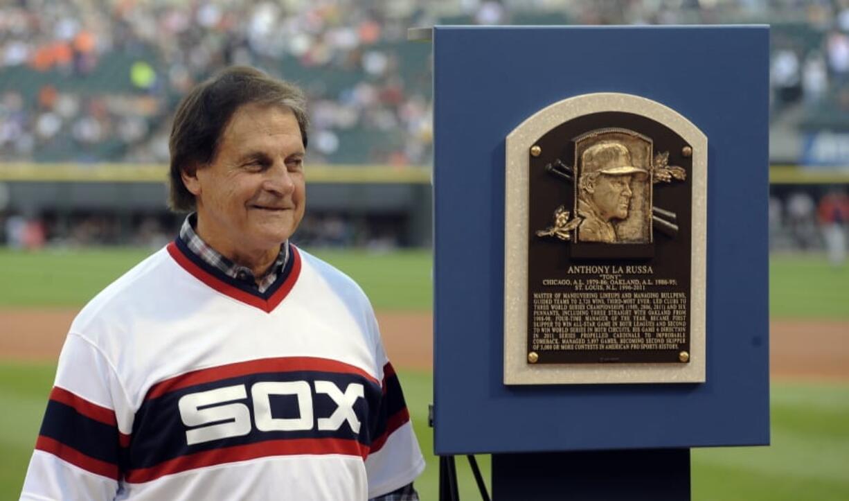 Former Chicago White Sox manager Tony La Russa stands with his Baseball Hall of Fame plaque in 2014 in Chicago. La Russa, the Hall of Famer who won a World Series championship with the Oakland Athletics and two more with the St. Louis Cardinals, is returning to manage the Chicago White Sox 34 years after they fired him, the team announced Thursday, Oct. 29, 2020.