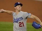 Los Angeles Dodgers starting pitcher Walker Buehler throws against the Tampa Bay Rays during the first inning in Game 3 of the baseball World Series Friday, Oct. 23, 2020, in Arlington, Texas.