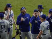 Los Angeles Dodgers starting pitcher Clayton Kershaw, center, celebrates after their 4-2 win against the Tampa Bay Rays in Game 5 of the World Series on Sunday.