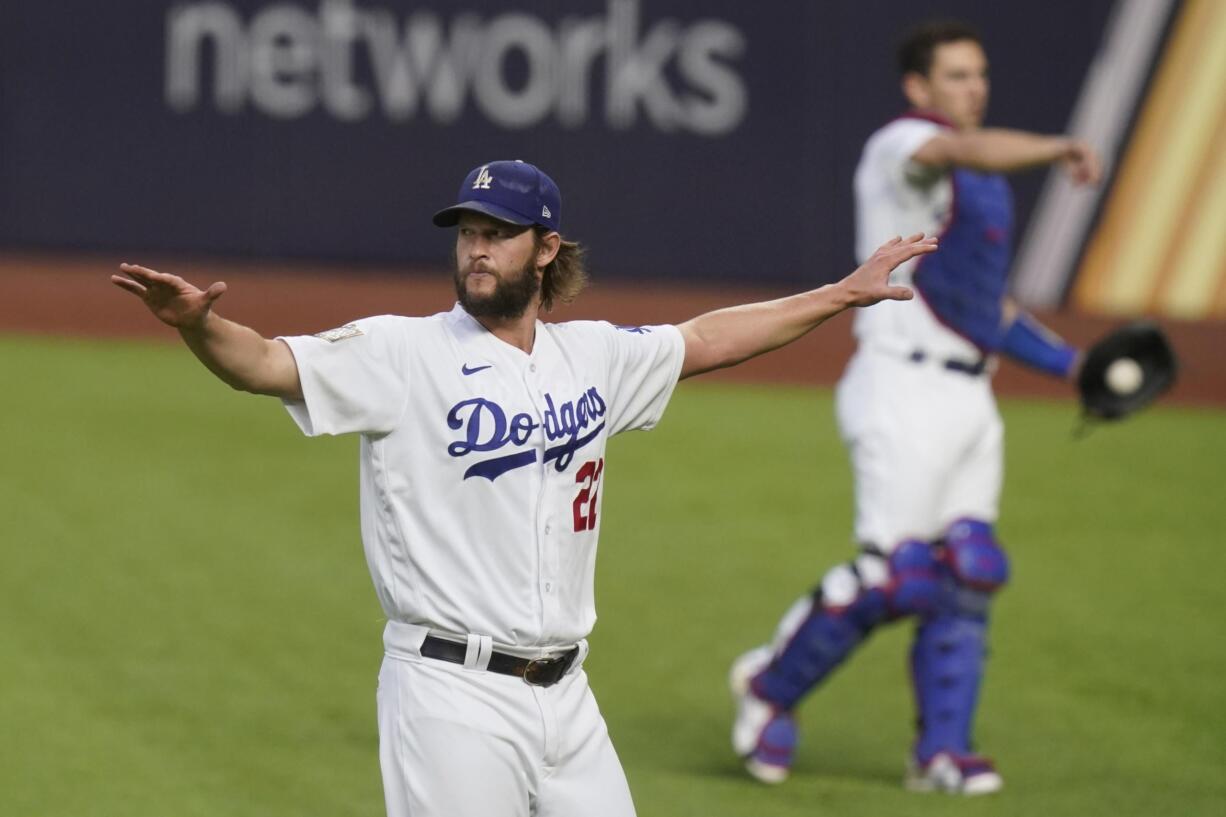 Los Angeles Dodgers starting pitcher Clayton Kershaw warms up before Game 1 of the baseball World Series against the Tampa Bay Rays Tuesday, Oct. 20, 2020, in Arlington, Texas.