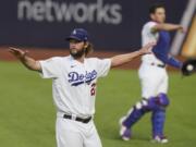 Los Angeles Dodgers starting pitcher Clayton Kershaw warms up before Game 1 of the baseball World Series against the Tampa Bay Rays Tuesday, Oct. 20, 2020, in Arlington, Texas.